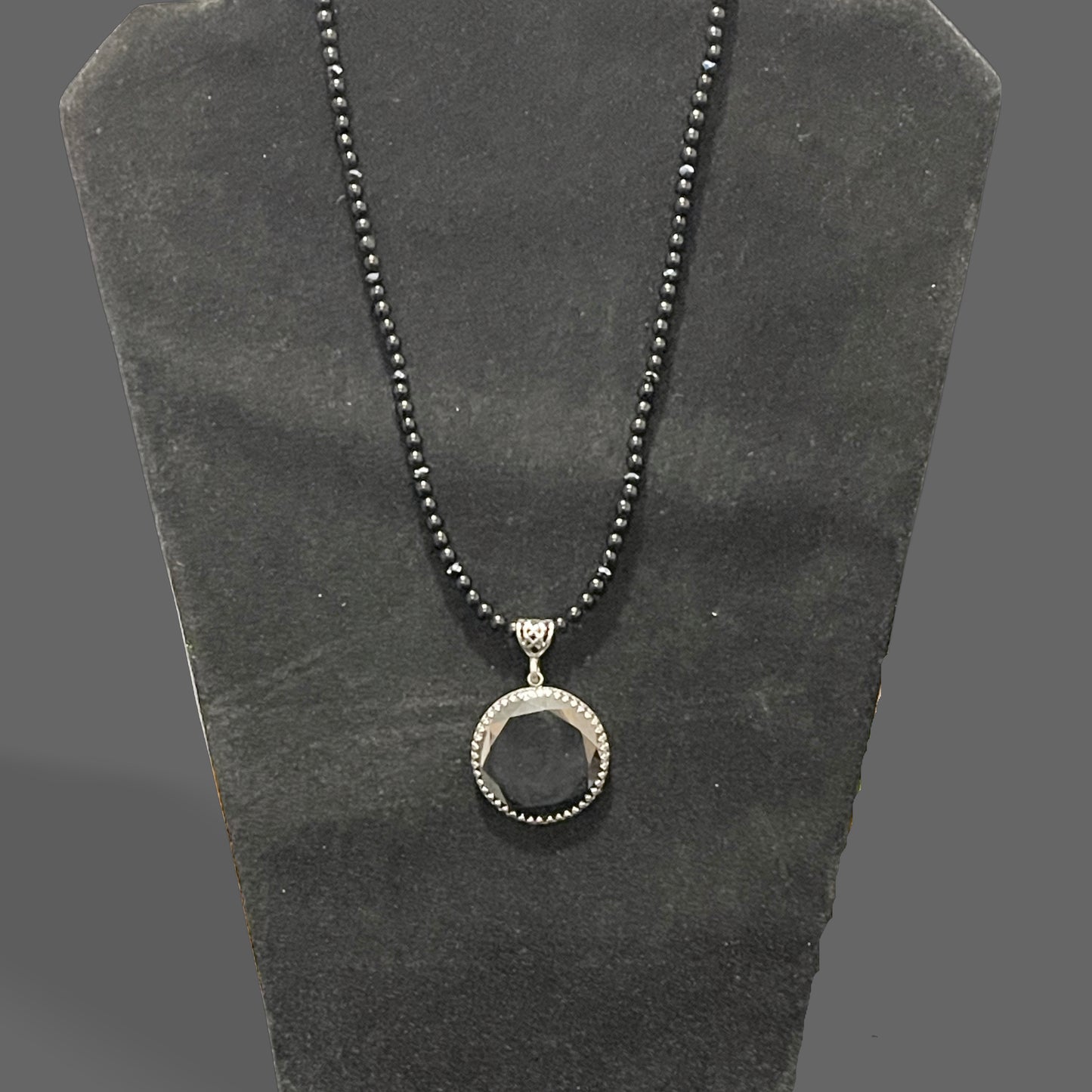 Pendant, black moissanite coin